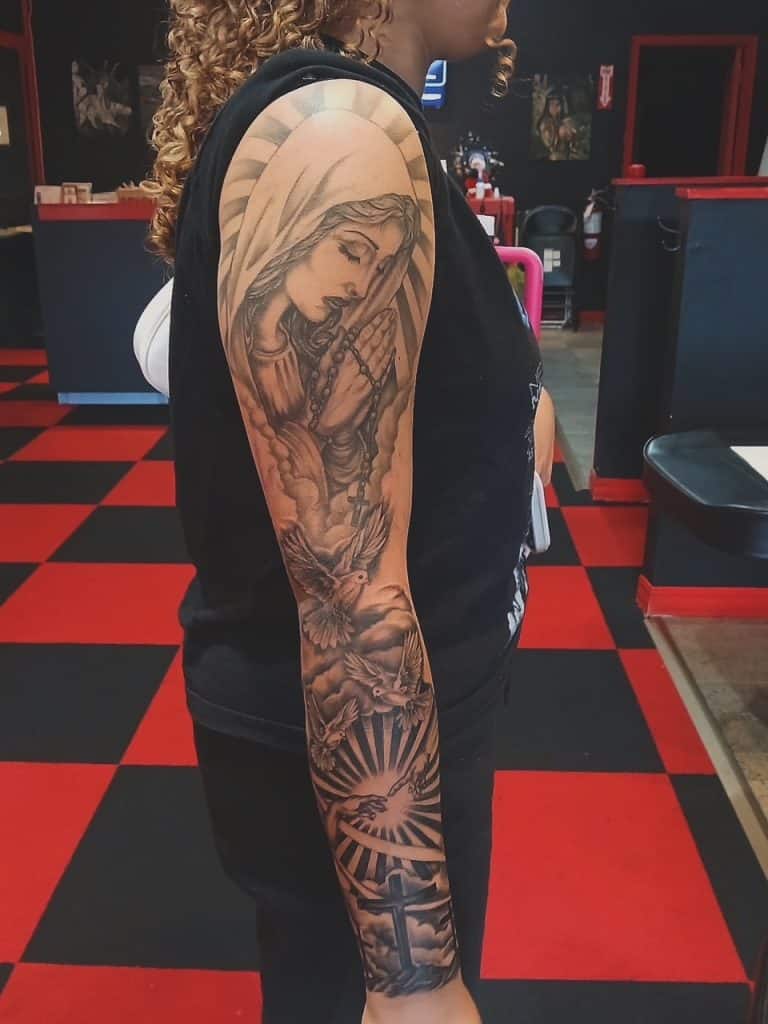 Detailed custom black and grey religious portrait tattoo inked by a professional artist at Mayhem Ink Tattoo in Nashua, NH.